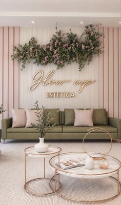 a living room filled with furniture and flowers on the wall above it's coffee table