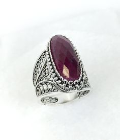 Ruby Corundum and Silver Statement Ring, DGS 925 Sterling Silver Artisan Crafted Filigree Elongated Oval Ring, Jewelry Gift Boxed for the art loving woman. Ring Size 5-12, This ring uses 8x22 mm long, genuine, approximately 9 carat total weight gemstone and it weights approximately 9.5 Grams. The length lends a feminine look. At the top the ring nears 0.8 Inches, and it tapers downward with its lacey filigree. This will come in a designer pouch, put in gift box and a romance card. It is a gift t Collectible Oval Ruby Ring In Silver, Silver Oval Ruby Ring Spiritual Style, Bohemian Silver Oval Ruby Ring, Ornate Silver Ruby Ring Oval, Silver Oval Cabochon Ruby Ring As Gift, Ornate Silver Oval Ruby Ring, Ornate Silver Ruby Ring With Oval Shape, Oval Silver Ruby Filigree Ring, Silver Oval Ruby Ring With Intricate Design