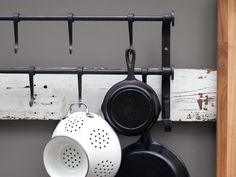 pots and pans are hanging on a rack