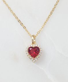 "This dainty gold heart necklace is made with a small cubic zirconia heart pendant which is full of sparkly CZs and dangles on a pretty gold cable chain. Simply choose which color CZ heart pendant you want from the drop down menu, and we will make it for you. This birthstone heart necklace is 18 inches long and makes a lovely jewelry gift for her. Thank you for looking. The beautiful model wearing this necklace is our customer, Minji, who creates the most gorgeous luxury swimwear, which you can Gold Necklaces With Sparkling Stones For Valentine's Day, Dainty Heart Pendant Necklace In Cubic Zirconia, Dainty Cubic Zirconia Necklace With Heart Charm, Heart Necklace With Cubic Zirconia For Valentine's Day, Cubic Zirconia Heart Charm Necklace, Heart Cut Cubic Zirconia Birthstone Necklace, Valentine's Day Gold Necklace With Sparkling Stones, Cubic Zirconia Heart Necklace With Gemstone, Dainty Cubic Zirconia Heart Pendant Necklace