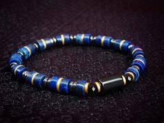 🎁 Explore this meticulously crafted handmade Lapis Lazuli bracelet designed for men, featuring Black Tourmaline and Gold Hematite accents in a minimalist style with 6mm beads, making it an ideal birthday gift choice. Material details: -8mm Black Tourmaline -6mm Lapis Lazuli -6mm Gold Hematite -4mm Hematite PACKAGING * Each piece of our bracelet is packaged in a black gift box with ribbon, perfect for gift-giving. ❤️ Black Tourmaline is ideal for individuals seeking protection from negative ener Blue Hematite Jewelry As A Gift, Blue Hematite Jewelry For Gift, Lapis Lazuli Bracelet Men, Luxury Men's Lapis Lazuli Jewelry, Gift Natural Stone Lapis Lazuli Beads, Luxury Lapis Lazuli Bracelet, Hand-strung Lapis Lazuli Spiritual Bracelets, Lapis Lazuli Bracelet, Lapis Lazuli Stone