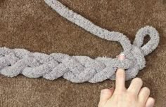 someone pointing at a rope on the floor