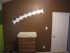 a baby's room with a crib and dresser