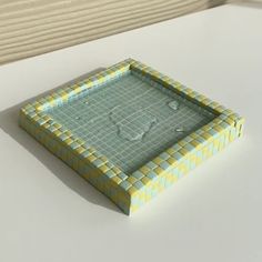 a yellow and blue tray sitting on top of a white table