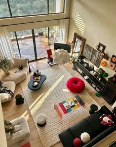 an aerial view of a living room with furniture and large windows overlooking the outdoors area