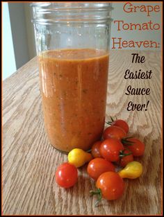 a jar filled with tomato sauce next to some tomatoes