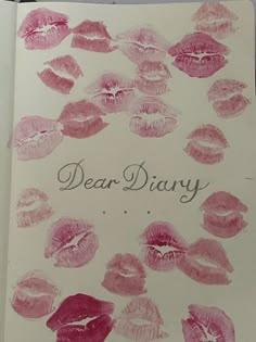 an open notebook with pink lipstick imprints and the words dear diary written on it