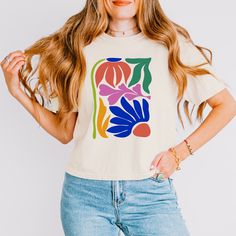 This unisex Matisse boxy shirt  is perfect for any Henri Matisse fan! It features a beautiful graphic in the style and with the original colors of the French artist's signature cutouts. Made from 100% cotton, this shirt is soft and comfortable to wear. Whether you're dressing up for a special occasion or just chilling out in your own home, this shirt is a great way to show your love for one of history's most celebrated artists. Order yours today and enjoy the classic style that Henri Matisse is Artistic Oversized Tops For Spring, White Artsy Tops For Spring, White Artsy Spring Tops, Artsy White Tops For Spring, Artsy White Spring Tops, Artistic Relaxed Fit T-shirt For Spring, Artsy Spring Tops With Graphic Print, Artsy Spring Top With Graphic Print, Artsy Graphic Print Tops For Spring