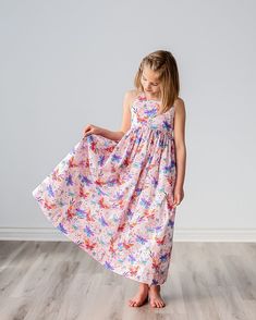 "Our girls sundress features a beautiful butterfly print on a soft pink background, a scoop neck, an elastic back waist and adjustable strappy neck tie.  Shown in a maxi length, our dress is also available in a midi or tea length.  The full skirt makes for fun twirling at birthday parties, family events, wedding receptions, church functions and other special events! Matching doll dresses can be added to your dress purchase by using the following listing:  https://www.etsy.com/listing/1598406363/ Pink Sleeveless Dress With Butterfly Print, Girls Midi Dress, Floral Meadow, Birthday Summer, Girls Sundress, Modesty Fashion, Doll Dresses, Wedding Receptions, Soft Floral