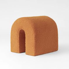 an orange chair made out of foam on a white background