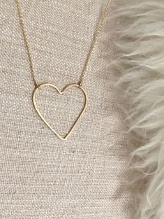 "Open Heart Necklace:  * Beautiful premium 14 karat gold-filled or sterling silver heart is hand-shaped and forged lending to the artisan quality that we love. * Choose your pendant size Regular heart: approximately 1\" Large heart: approximately 1.375\"W x 1.5\"H * Dainty and light Rolo chain gives this necklace a modern, smooth look that is so pretty. It's a perfect match for the elegant open line style heart pendant. * Comes in 17\" length chain with an option to add a 2\" extender chain. Ple Everyday Brass Heart Pendant Jewelry, Minimalist Heart-shaped Nickel-free Jewelry, Minimalist Nickel-free Heart-shaped Jewelry, Minimalist Heart Shaped Nickel-free Jewelry, Minimalist Nickel-free Heart Jewelry, Dainty Heart-shaped Brass Jewelry, Heart-shaped Brass Jewelry For Wedding, Heart-shaped Brass Wedding Jewelry, 14k Gold Filled Jewelry For Valentine's Day Wedding