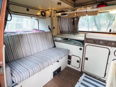 the inside of a camper with a couch and stove in it's center