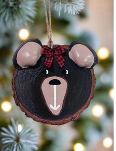 a bear ornament hanging from a christmas tree