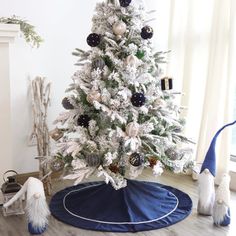 a white christmas tree with black and silver ornaments