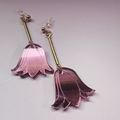 Expertly crafted from pink mirror acrylic and brass, these Sabrine Tulip Earrings feature a 14k gold-filled stud and measure a sleek and stylish 2-1/4 inches in length. Every piece of jewelry is hand formed and hand assembled by me. Due the unique nature of the product you may not get the pictured earrings. Tulip Earrings, Black Glaze, Pink Mirror, Mirror Acrylic, Black Stud, Floral Hoops, Unique Nature, Steel Post, Half Circle