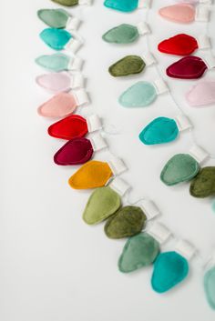 a string of felt hearts on a white background