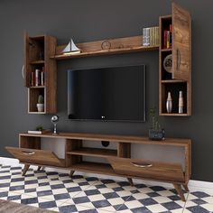 an entertainment center with bookshelves and a flat screen tv mounted on the wall