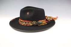 The Babylon Fedora Take yourself to hat heaven with The Babylon. The perfect name for this stunning fedora. Featuring a vintage paisley silk fabric band as the base for this hat. Over the top we have used a faux  suede band that features a lucious concho with a gold filagree design. The feathers used for this hat are a mixture of Rooster and Pheasant. Features tiger eye and black onyx stones. *Please note these are all handmade and that may result in some subtle differences to the hat you receive, we believe this is a good thing as it ensures our hats are always unique* Hat Colour: Black This hat is available in 4 sizes. - Small - 55cm. Height 9-10cm approx - Medium - 57cm. Height 9-10cm approx - Large - 59cm. Height 10-11cm approx - Extra Large 61cm Height 10-11cm approx (Please note this Vintage Fedora For Festival, Vintage Fitted Fedora For Festival, Fitted Vintage Fedora For Festival, Vintage Festival Hat With Flat Brim, Vintage Flat Brim Hat For Festivals, Vintage Flat Brim Festival Hat, Festival Top Hat With Short Brim, Vintage Flat Brim Fedora For Festivals, Vintage Brimmed Fedora For Festivals