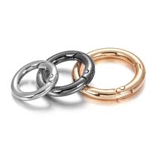 three different colored metal rings on a white background