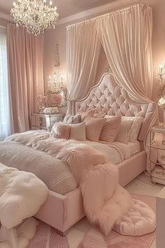 a bedroom decorated in pink and white with chandelier