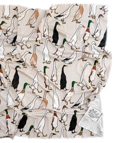 a white blanket with ducks and geese on it's sides, as well as an image of the same bird