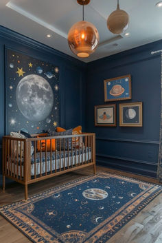 a baby's room with blue walls and pictures on the wall, including a crib