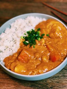 a white bowl filled with rice and curry