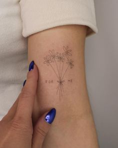 a woman's arm with flowers and the words i love you written on it