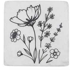 a black and white drawing of flowers on a square stone coaster with thin line work