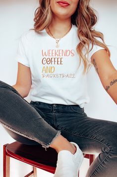 a woman sitting on top of a stool wearing a t - shirt that says coffee makes me feel alive