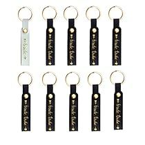 eight black and gold keychains with the word love written on them