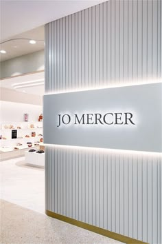 the entrance to jo merger's store with its name illuminated on the wall