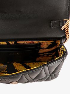 Versace Black Mini Nappa Leather Crossbody Bag. Featuring a branded logo and a solid black color, this bag is secured with a magnetic fastening and comes with a versatile crossbody strap that is adjustable to your comfort. The bag is made in Italy, with a multicolor inner lining with an inside pocket for added organization. Complete with logo engraved metal hardware. Model: Crossbody bag Material: 100% AOS, 100% PL Color: Black Multicolor inner lining with inside pocket Handle: Adjustable should Black Business Bag With Chain Strap, Luxury Leather Belt Bag With Branded Hardware, Luxury Crossbody Belt Bag For Business, Luxury Black Belt Bag With Detachable Strap, Luxury Belt Bag With Adjustable Strap, Designer Black Belt Bag With Detachable Strap, Black Business Shoulder Bag With Chain Strap, Luxury Crossbody Belt Bag With Adjustable Strap, Luxury Black Belt Bag As Shoulder Bag