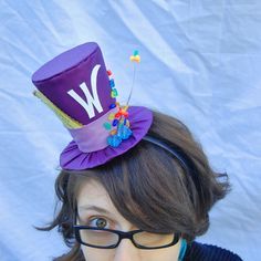 a woman wearing glasses and a purple hat