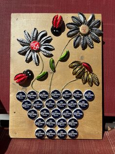 a bunch of buttons sitting on top of a wooden plaque