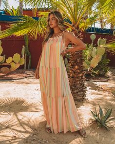 Relaxed Fit Self & Lining¨C 100% Polyester Hand Wash Cold. Dry Flat Maxi Length Scoop Neckline Flowy Body Smocked Chest and Upper Back Adjustable Shoulder Tie Closure Fully Lined Our Copeland Smocked Tiered Tassel Maxi Dress will inspire you to take a vacay! Yellow. mint. salmon. and peach stripes make up this tiered maxi. Finished with adjustable tassel tie straps. Styled with the Emperor Coin Necklace and Brianne Twisted Faux Leather Sandal.---SIZE AND FIT---Model is Wearing a Size Medium. Bohemian Multicolor Smocked Dress For Vacation, Tiered Multicolor Smocked Dress For Summer, Pink Maxi Length Smocked Dress For Beach, Pink Smocked Maxi Dress For Beach, Pink Maxi Smocked Dress For Beach, Pink Maxi Length Smocked Dress For Vacation, Pink Smocked Maxi Dress For Vacation, Pink Maxi Smocked Dress For Vacation, Bohemian Smocked Maxi Dress For The Beach