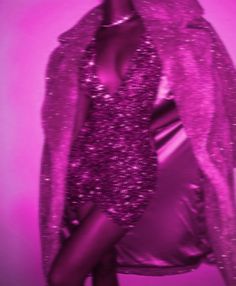 a woman in a shiny purple dress and jacket