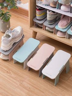 three small stools sitting next to each other in front of a shoe rack