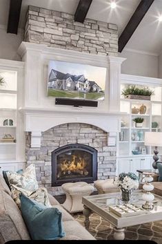 a living room filled with furniture and a flat screen tv mounted above a fire place