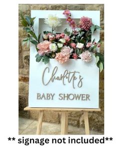 a baby shower sign with flowers on it