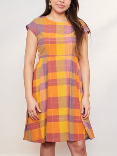 This classic fit and flare dress is a fast customer favorite, especially in this new, playful, warm toned plaid. Dress it up for dinner or go casual with sandals - the Devonshire can be whatever you need it to be. 100% cotton Hidden pockets Zips at back Length of size M is 39" from top of bodice Made fair trade in Nepal by one of our longstanding production partners Casual A-line Plaid Dress, Plaid Cotton A-line Dress, Casual Gingham Plaid A-line Dress, Fitted Cotton Plaid Dress Casual Style, Casual Cotton Plaid Midi Dress, Spring Cotton A-line Plaid Dress, Casual Cotton Plaid Dress For Picnic, Cotton Plaid Dress For Fall Picnic, Fall Cotton Plaid Dress For Picnic