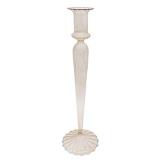 a tall white glass vase with a base