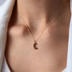 14K Gold Mini Moon Necklace:  Materials & Specifications:  - 14k yellow gold pendant and chain - Moon pendant measures 1.2cm x 0.9cm - Pendant is hollow Available in 4 different chain lengths: 42cm (16.5 in), 45cm (17.7 in), 47cm (18.5 in), 49cm (19.3 in). As with all of our products, this item is handmade and made to order.  **WEARING YOUR JEWELRY** Show your love to your beautifully handcrafted pieces!  Although we stand behind the craftsmanship of our jewelry, our pieces are delicate and not 14k Gold Filled Moon Charm Necklace As A Gift, Dainty Crescent Yellow Gold Charm Necklaces, Dainty Yellow Gold Crescent Charm Necklaces, 14k Gold Filled Moon Jewelry Gift, 14k Gold Filled Moon Charm Jewelry Gift, Dainty Yellow Gold Moon Charm Necklace, Yellow Gold Crescent Charm Necklace As Gift, 14k Gold Moon Charm Necklace For Gift, Dainty 14k Gold Moon Charm Jewelry