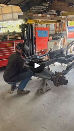 a man working on a car in a garage