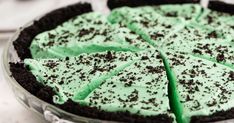 a pie with green frosting and chocolate sprinkles