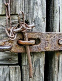 an old rusted metal latch on a wooden door