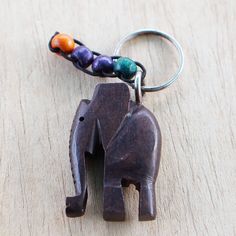 an elephant keychain with beads hanging from it