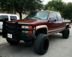 a red pick up truck parked on the street