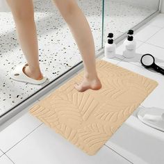 a person standing on a bathroom rug in front of a mirror