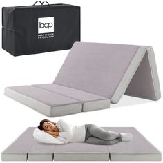 a woman laying on top of a bed next to a black box